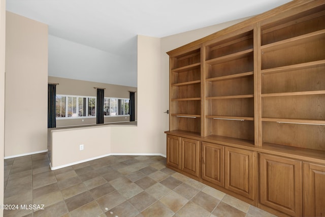 spare room featuring vaulted ceiling