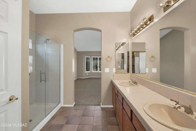 bathroom with tile patterned flooring, vanity, and an enclosed shower