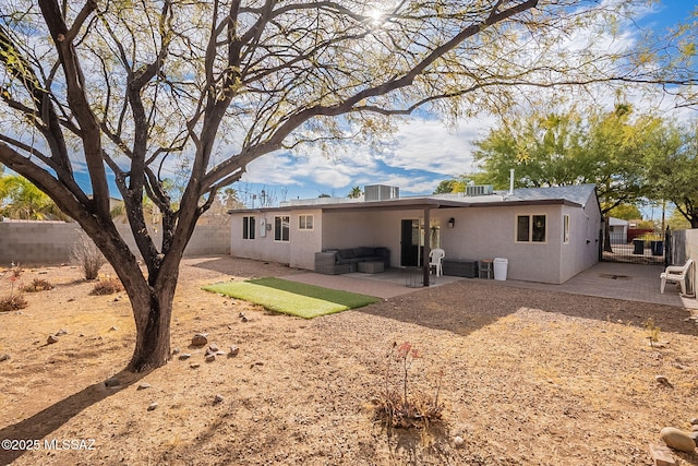 rear view of property featuring outdoor lounge area, central air condition unit, and a patio area