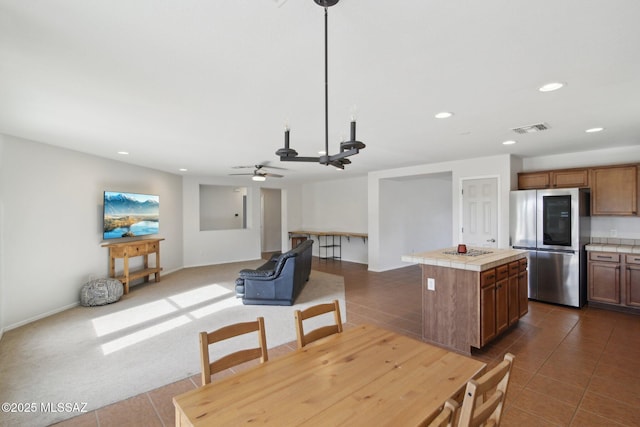 tiled dining area featuring ceiling fan