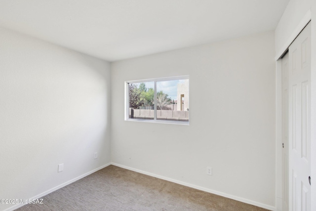 unfurnished bedroom featuring carpet flooring and a closet