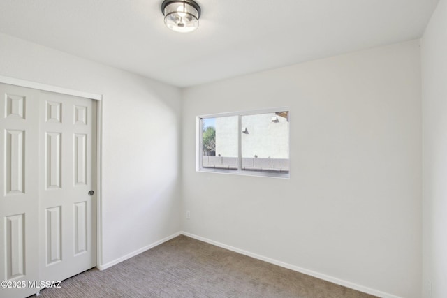 unfurnished room featuring carpet