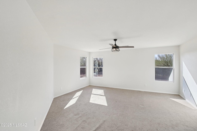 unfurnished room with ceiling fan and light carpet