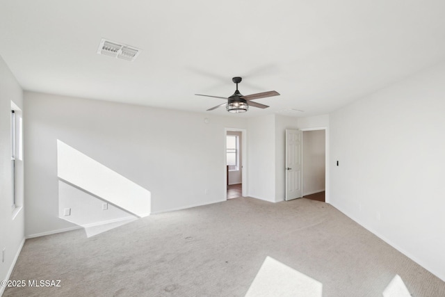 empty room with light carpet and ceiling fan