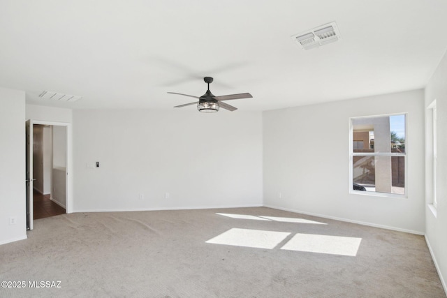 carpeted empty room featuring ceiling fan