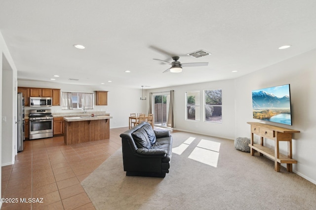 tiled living room with ceiling fan