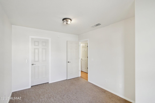 unfurnished bedroom with light carpet