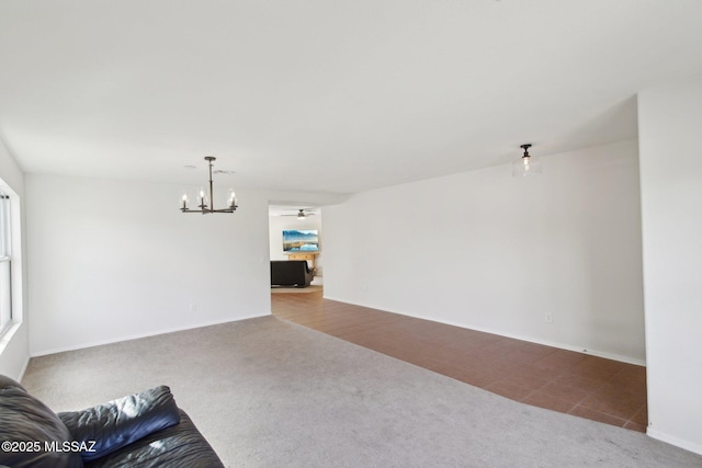 unfurnished living room with tile patterned floors and a chandelier