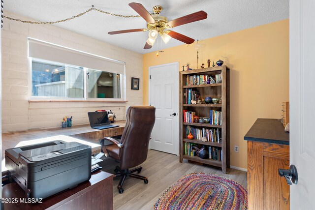tiled bedroom featuring baseboards, a textured ceiling, and ceiling fan