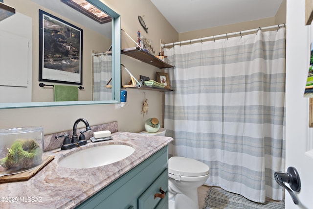 bathroom featuring tile patterned floors, vanity, and toilet