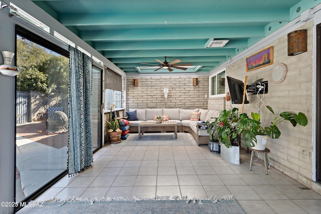 unfurnished sunroom featuring beam ceiling and ceiling fan