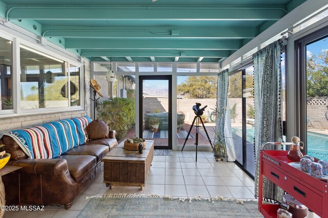 sunroom featuring visible vents, ceiling fan, an outdoor living space, and beamed ceiling