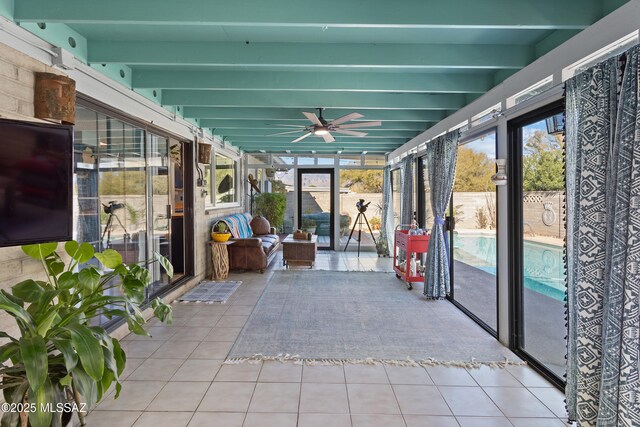 sunroom / solarium with an outdoor living space, ceiling fan, and beam ceiling