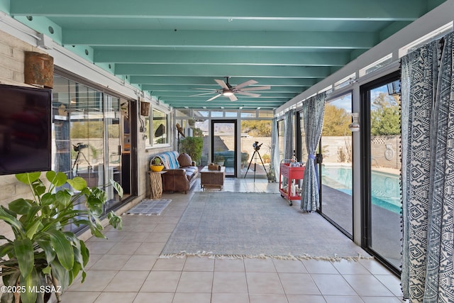 unfurnished sunroom with ceiling fan and beam ceiling