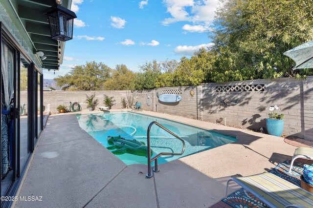 view of swimming pool with a patio, a fenced backyard, a fenced in pool, a diving board, and a mountain view