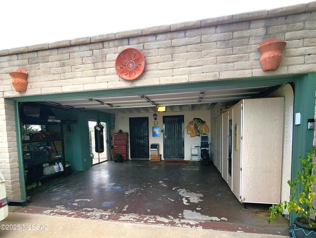 home office with concrete block wall and concrete floors