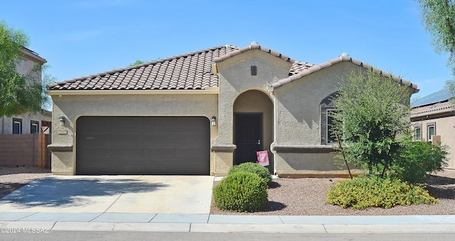 mediterranean / spanish-style home with a garage