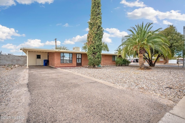 single story home with a carport