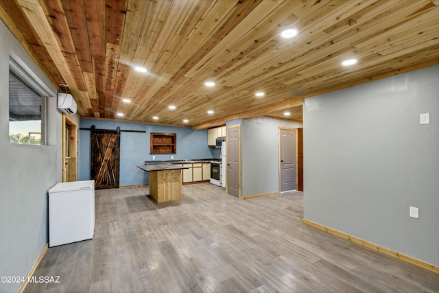 kitchen with a barn door, white range, an AC wall unit, and wooden ceiling