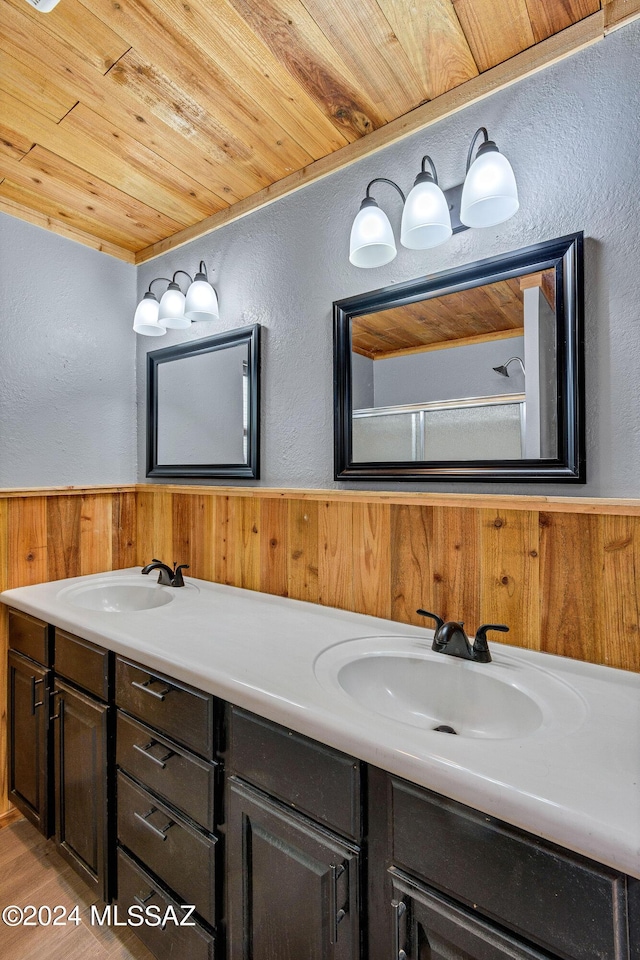 bathroom featuring wood walls, vanity, and wood ceiling