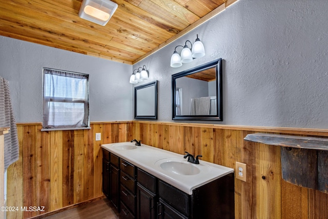 bathroom featuring vanity, hardwood / wood-style flooring, wooden ceiling, and wood walls