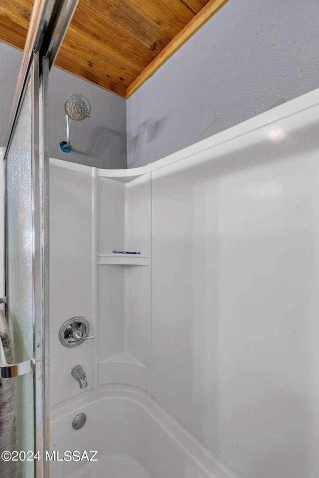 bathroom with bathing tub / shower combination and wooden ceiling