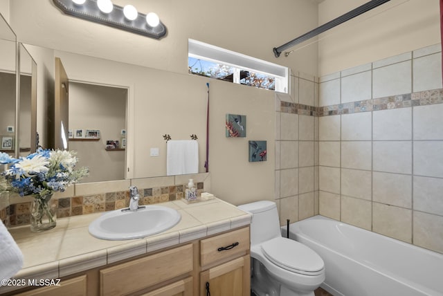 full bathroom featuring toilet, vanity, and tiled shower / bath