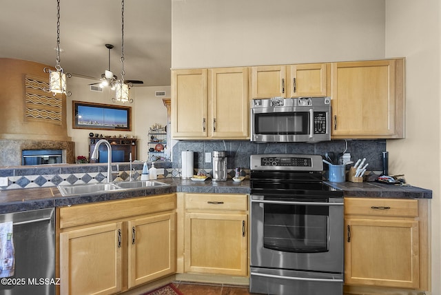 kitchen featuring tasteful backsplash, tile patterned floors, stainless steel appliances, sink, and light brown cabinets