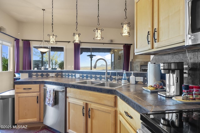 kitchen with sink, light brown cabinets, hanging light fixtures, backsplash, and appliances with stainless steel finishes