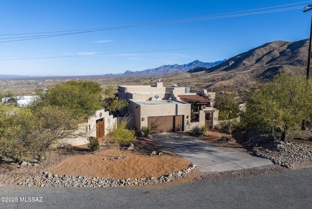 view of front of property with a mountain view and a garage