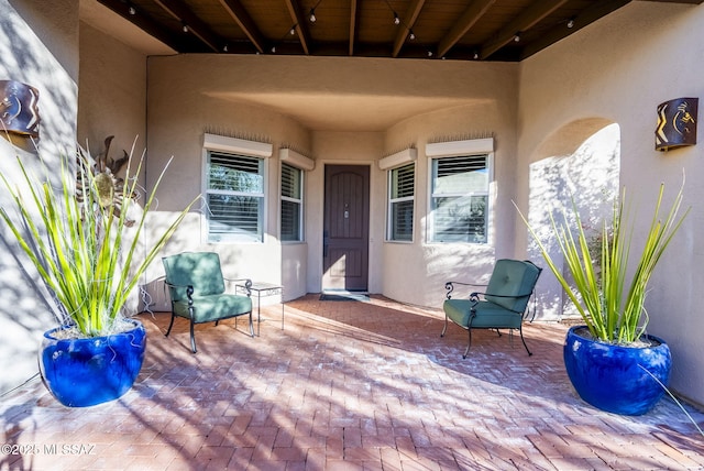 entrance to property featuring a wall mounted air conditioner and a patio area