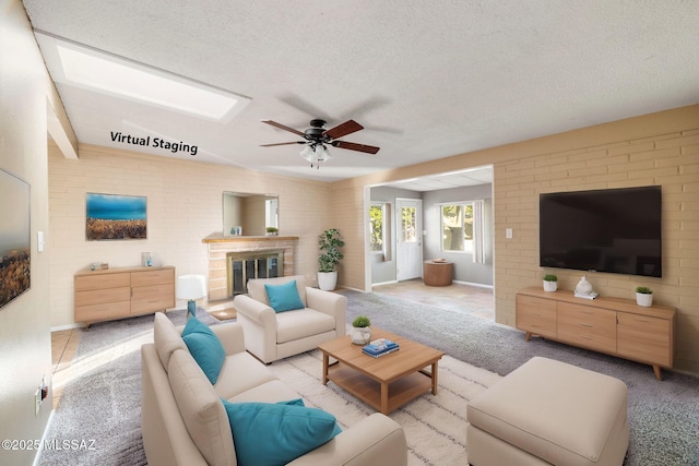 carpeted living room with ceiling fan and a textured ceiling