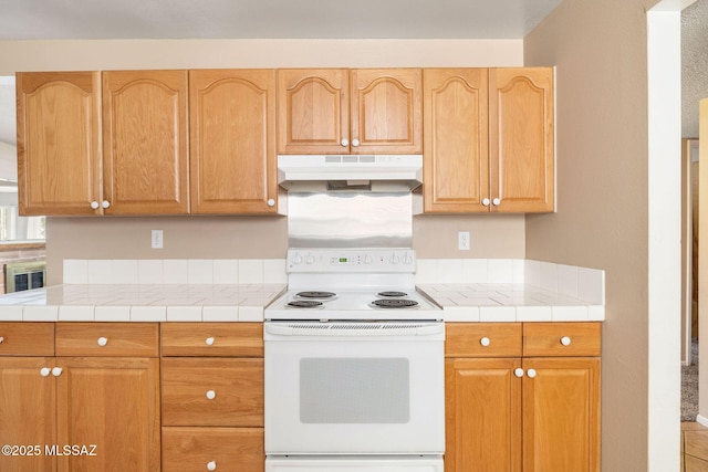 kitchen featuring tile countertops and white range with electric stovetop