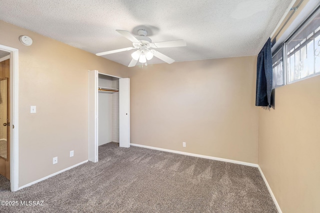 unfurnished bedroom featuring ceiling fan, carpet, a closet, and a textured ceiling