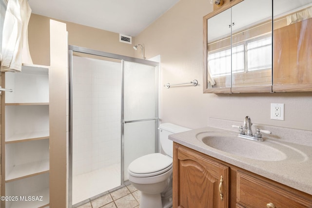 bathroom featuring walk in shower, tile patterned floors, toilet, and vanity