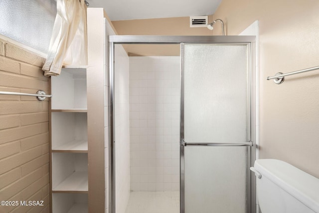 bathroom with toilet and walk in shower