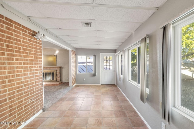 unfurnished sunroom with a drop ceiling