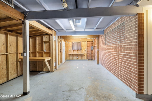 basement featuring brick wall