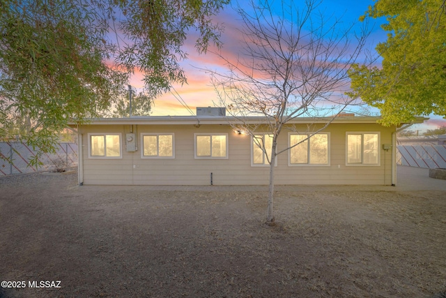 view of back house at dusk