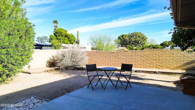 view of patio / terrace with outdoor dining area and fence