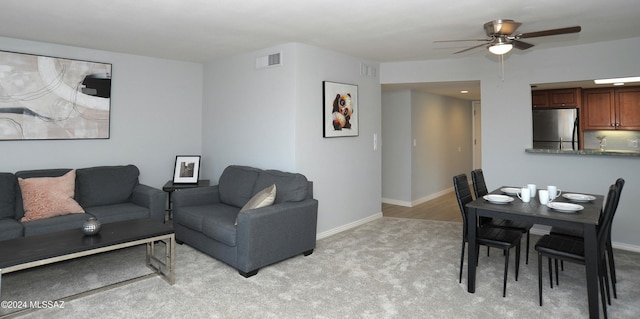 living room featuring light colored carpet and ceiling fan