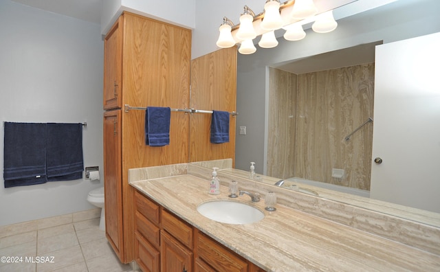 bathroom with toilet, vanity, tile patterned floors, and walk in shower