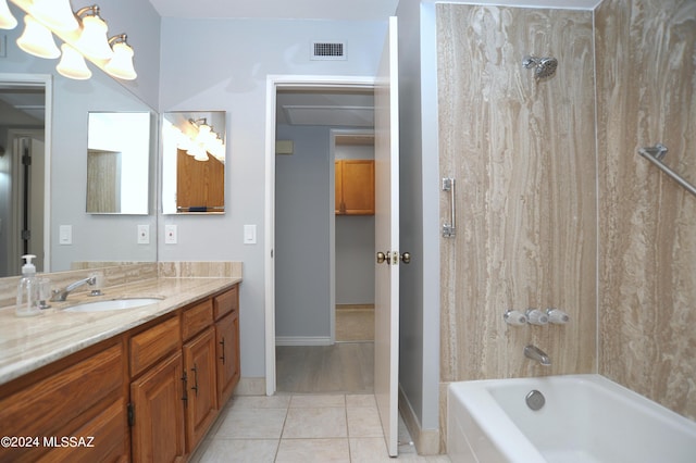 bathroom featuring tile patterned flooring, tiled shower / bath combo, and vanity