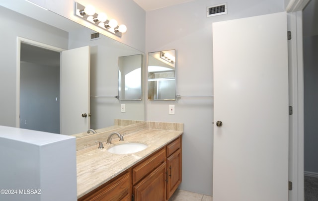 bathroom featuring tile patterned flooring and vanity