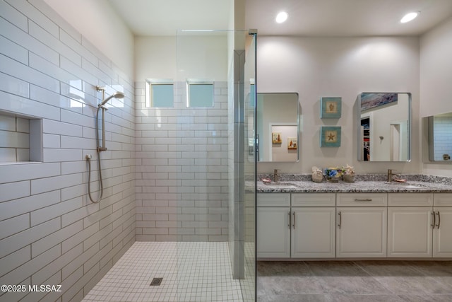 bathroom featuring vanity and a tile shower