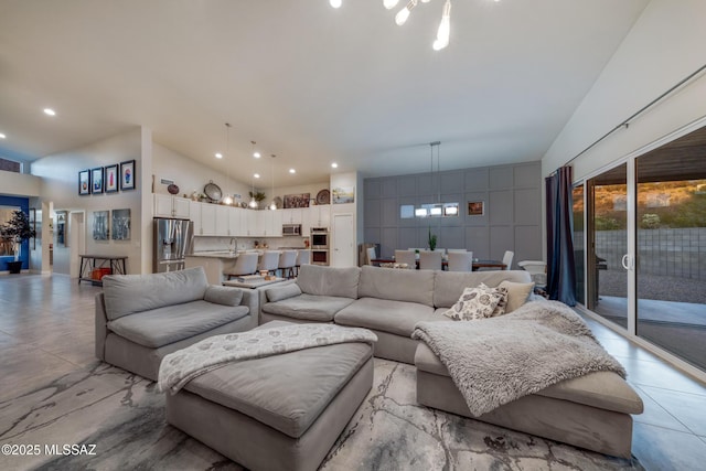living area with an inviting chandelier, high vaulted ceiling, and recessed lighting