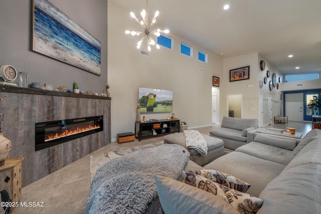 living room featuring a notable chandelier and a tiled fireplace