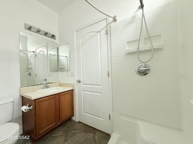 bathroom featuring tile patterned flooring, vanity, toilet, and walk in shower