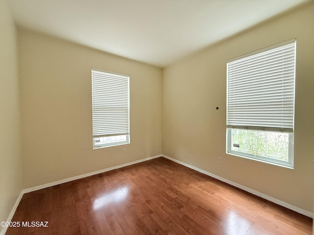 spare room with hardwood / wood-style flooring