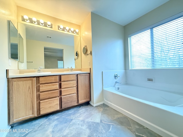 bathroom featuring vanity and a bath